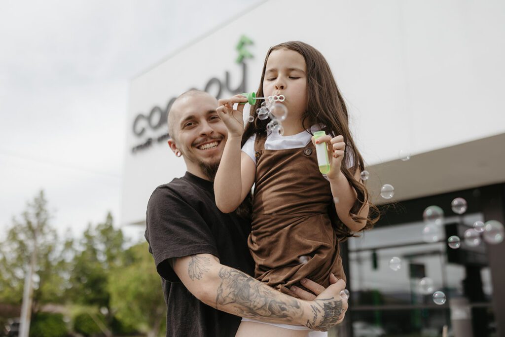 A father and daughter outside of a Canopy CU building.