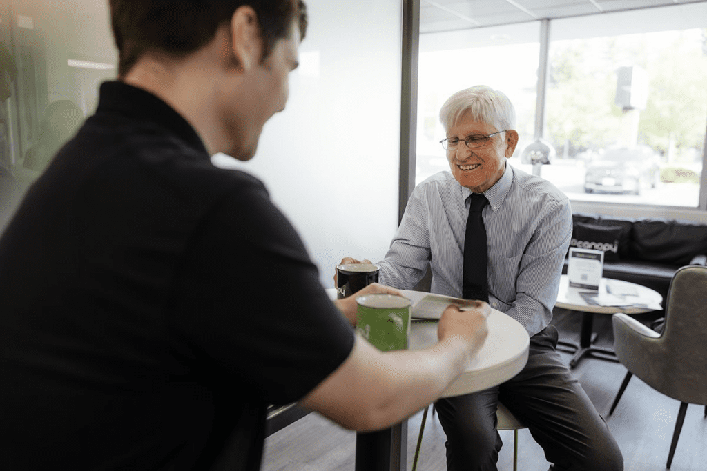 An elderly gentleman having a conversation with a Canopy Employee.