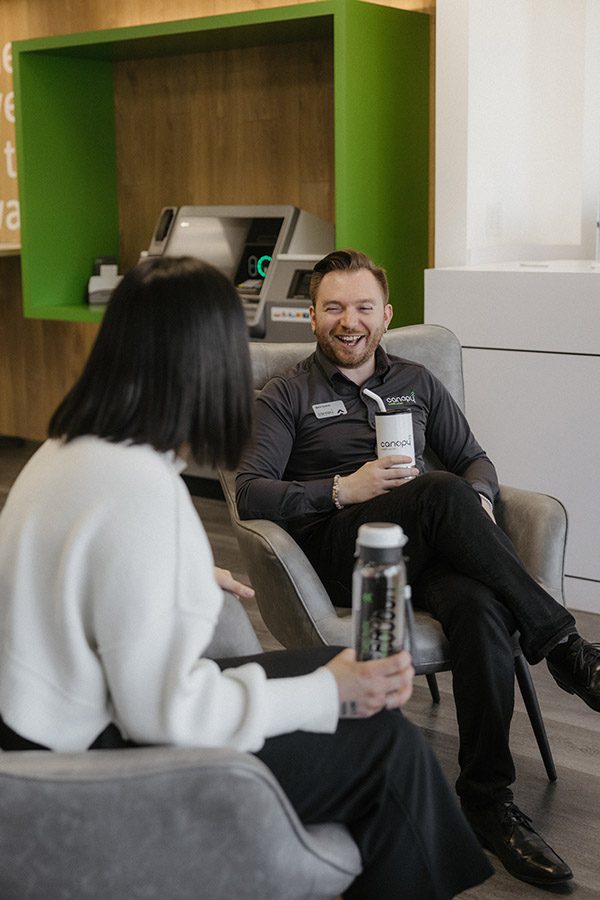 A Canopy CU team member laughing jovially with a Canopy Member.