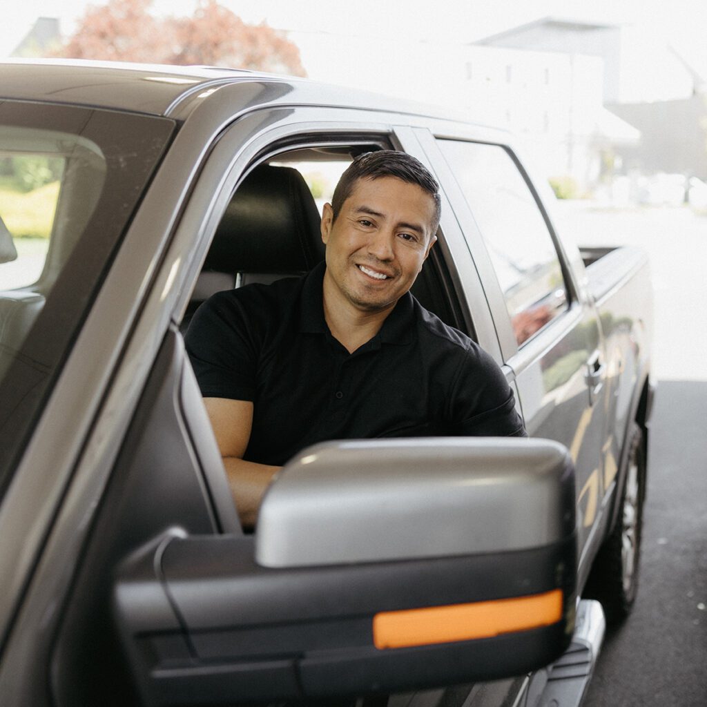 A happy Canopy member in their new truck.