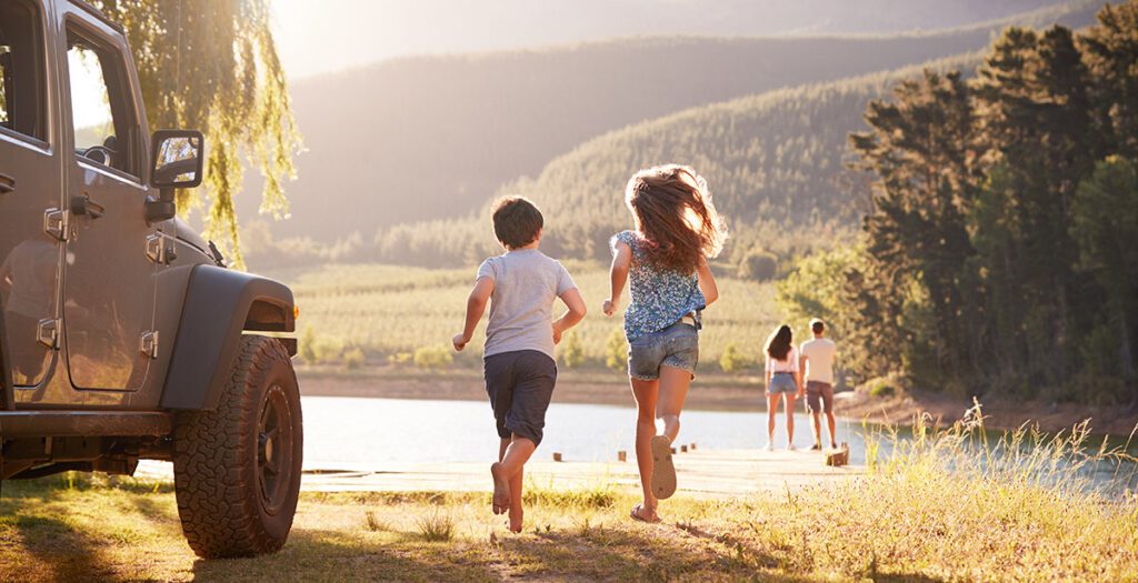 An excited family running in the country.